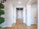 Inviting hallway with elegant tile flooring, white trim, and decorative plants, leading to various rooms at 7125 Mountain Den Ave, Las Vegas, NV 89179