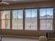 Bright living room featuring mountain views from the large windows with desert landscaping at 7125 Mountain Den Ave, Las Vegas, NV 89179