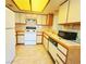 Galley kitchen with white appliances and wood cabinets at 1333 Del Mar St # 202, Las Vegas, NV 89119