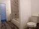 Updated bathroom with a bathtub and marble-style shower surround at 417 Antelope Way, Las Vegas, NV 89145