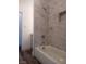 Clean bathroom with a shower/tub combo and marble-look tile at 417 Antelope Way, Las Vegas, NV 89145