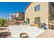 Backyard patio with barbecue, table, chairs, and desert landscaping at 6409 Dundock Ave, Las Vegas, NV 89122