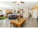 Open concept living room with wood look tile flooring and views into kitchen at 6409 Dundock Ave, Las Vegas, NV 89122