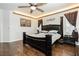 Relaxing main bedroom features a ceiling fan, wood-look floors, and stylish decor at 6409 Dundock Ave, Las Vegas, NV 89122