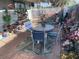 Relaxing covered patio with seating area, brick flooring, and colorful flowerpots at 620 N 16Th St, Las Vegas, NV 89101