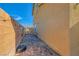 A narrow backyard with brick pavers and a wall at 1065 Admiral Emblem St, Henderson, NV 89015