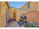 This backyard has brick with a barbecue, bike, and door leading into the home at 1065 Admiral Emblem St, Henderson, NV 89015