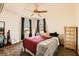 A bedroom bathed in natural light with a ceiling fan, large window, and ample space at 1065 Admiral Emblem St, Henderson, NV 89015