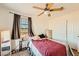 This bedroom has a ceiling fan, natural light through the windows and carpeted floors at 1065 Admiral Emblem St, Henderson, NV 89015