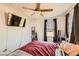 Comfortable bedroom showcasing a ceiling fan, large windows, and a modern television set at 1065 Admiral Emblem St, Henderson, NV 89015