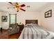 Bedroom with hardwood floors, ceiling fan, and chair at 1065 Admiral Emblem St, Henderson, NV 89015