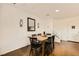 Dining area features wooden table, black chairs, mirror, and decorative sconces at 1065 Admiral Emblem St, Henderson, NV 89015