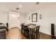 Bright dining area features hardwood floors, a wooden table, and a modern mirror at 1065 Admiral Emblem St, Henderson, NV 89015