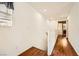 Hallway with laminate flooring, bright lighting, and white railing at 1065 Admiral Emblem St, Henderson, NV 89015