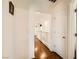 Well-lit hallway featuring sleek wood floors and white walls at 1065 Admiral Emblem St, Henderson, NV 89015