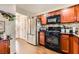 Well lit kitchen featuring stainless steel appliances, wooden cabinets, and a black stove at 1065 Admiral Emblem St, Henderson, NV 89015