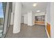 Spacious living area with tile flooring, columns, and a modern kitchen in the background at 3726 Las Vegas Blvd # 1902, Las Vegas, NV 89158