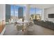 Living room featuring a dining table, chairs, and a sofa with floor-to-ceiling windows offering city views at 3726 Las Vegas Blvd # 1902, Las Vegas, NV 89158