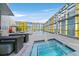 Luxury rooftop pool area featuring a jacuzzi, lounge seating, and modern glass architecture with city views at 3726 Las Vegas Blvd # 1902, Las Vegas, NV 89158