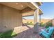 Covered back patio with pavers, artificial grass, and outdoor seating area for relaxing at 10254 Baronia St, Las Vegas, NV 89141