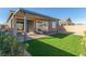 Backyard featuring a covered patio, artificial grass, and ample room for outdoor activities and relaxation at 10254 Baronia St, Las Vegas, NV 89141