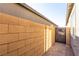 Side yard showcasing a walkway, block wall, and access to the backyard through an iron gate at 10254 Baronia St, Las Vegas, NV 89141