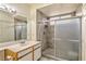 Modern bathroom features an updated shower with glass doors and a large vanity mirror at 4960 Harrison Dr # 214, Las Vegas, NV 89120