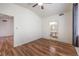 Bedroom with hardwood floors, ceiling fan, and bathroom and closet access at 4960 Harrison Dr # 214, Las Vegas, NV 89120