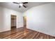 Bedroom with hardwood floors, ceiling fan, and access to both a closet and hallway at 4960 Harrison Dr # 214, Las Vegas, NV 89120