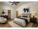 Virtually staged bedroom features a bed, dresser, and comfortable seating area at 4960 Harrison Dr # 214, Las Vegas, NV 89120