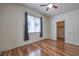 Spacious bedroom featuring a large window, hardwood floors, and a walk-in closet at 4960 Harrison Dr # 214, Las Vegas, NV 89120