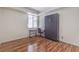 Bright bedroom with a built-in Murphy bed, a work desk, and attractive wood-look floors at 4960 Harrison Dr # 214, Las Vegas, NV 89120