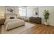 Beautifully staged bedroom with a large window, hardwood floors, and neutral decor at 4960 Harrison Dr # 214, Las Vegas, NV 89120