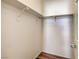 Walk-in closet featuring wood-look floors and shelves with hanging storage at 4960 Harrison Dr # 214, Las Vegas, NV 89120