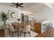 Bright dining area featuring a modern ceiling fan and seating for six adjacent to the kitchen with stainless steel appliances at 4960 Harrison Dr # 214, Las Vegas, NV 89120