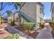 Well-maintained condo building with manicured landscaping and private entry stairs at 4960 Harrison Dr # 214, Las Vegas, NV 89120