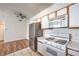 Efficient kitchen includes stainless steel refrigerator and white gas range at 4960 Harrison Dr # 214, Las Vegas, NV 89120