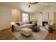 Inviting living room featuring a fireplace, plush sofa with an ottoman, and a neutral color palette at 4960 Harrison Dr # 214, Las Vegas, NV 89120
