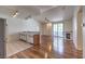 Open-concept living area features hardwood floors, fireplace, and sliding glass doors to balcony at 4960 Harrison Dr # 214, Las Vegas, NV 89120