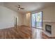 Spacious living room featuring hardwood floors, a fireplace, and sliding glass doors to an outdoor area at 4960 Harrison Dr # 214, Las Vegas, NV 89120