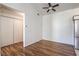 Spacious living room area featuring wood-like flooring, ceiling fan, and a closet at 4960 Harrison Dr # 214, Las Vegas, NV 89120