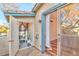 View of an outdoor patio with an open door, sliding glass doors and utility closet at 4960 Harrison Dr # 214, Las Vegas, NV 89120