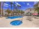 Relaxing community pool and hot tub surrounded by lounge seating and lush landscaping at 4960 Harrison Dr # 214, Las Vegas, NV 89120