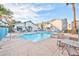 Community pool with lounge chairs and tables for relaxing poolside at 4960 Harrison Dr # 214, Las Vegas, NV 89120