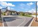 View of the outdoor basketball court and covered patio with stone pillars and a tiled roof at 1 Olympia Canyon Way, Las Vegas, NV 89141