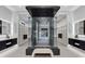 Modern bathroom with a luxurious walk-in shower, dual vanities, and custom closet space with ample storage at 1 Olympia Canyon Way, Las Vegas, NV 89141