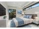 Stylish bedroom with blue accents, natural light, and a sliding glass door to the backyard at 1 Olympia Canyon Way, Las Vegas, NV 89141