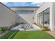 Modern courtyard featuring a built-in fire pit and artificial grass at 1 Olympia Canyon Way, Las Vegas, NV 89141