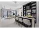 Contemporary dining area with bar, sleek chairs, modern lighting, and adjacent kitchen offering a stylish space at 1 Olympia Canyon Way, Las Vegas, NV 89141