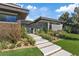 Stunning modern home featuring stone accents, a walkway, professional landscaping, and an inviting entrance at 1 Olympia Canyon Way, Las Vegas, NV 89141